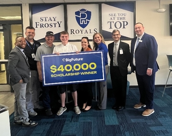 Male student holding $40,000 jump check after winning a BigFuture Scholarship